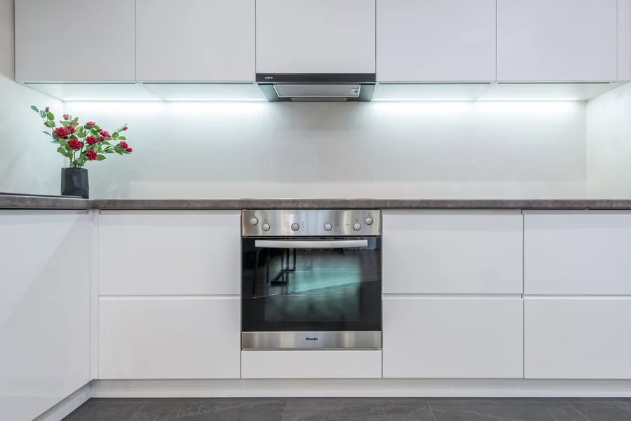 Sound white builder-spec kitchen units and worktop worth keeping in a Liverpool new build