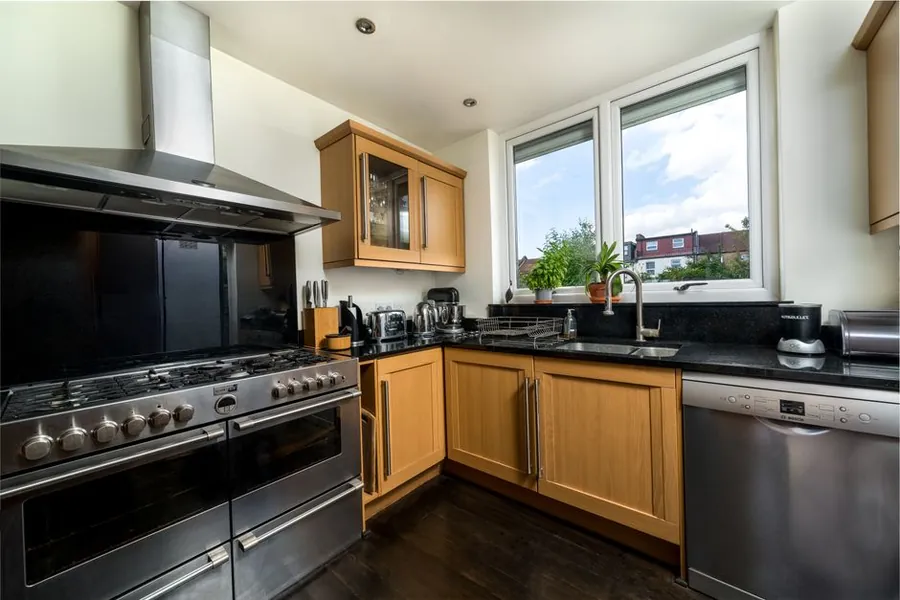 Fitted kitchen with range cooker and stainless steel appliances in a Merseyside home supplied with soft water