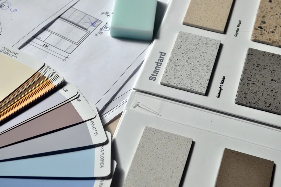 Worktop samples and a kitchen plan used to price a builder-spec kitchen upgrade in Liverpool