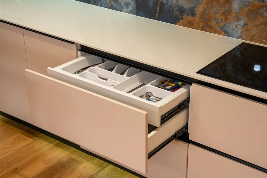 Open kitchen drawer showing the drawer box and runner on a builder-spec new build kitchen unit