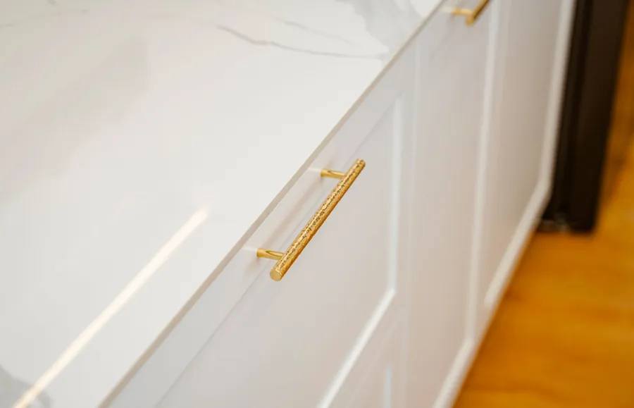 Brushed brass bar handles fitted to white kitchen cabinet doors during a Liverpool new build kitchen upgrade