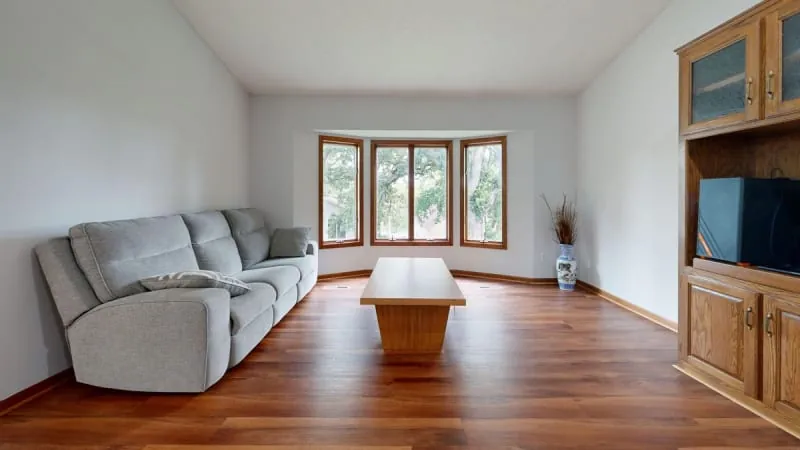 Living room bay window with seating area and wooden floors