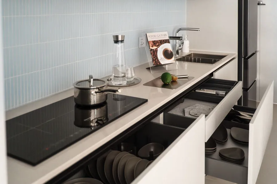 Deep kitchen drawers pulled open showing storage brought out to standing height in a Liverpool kitchen