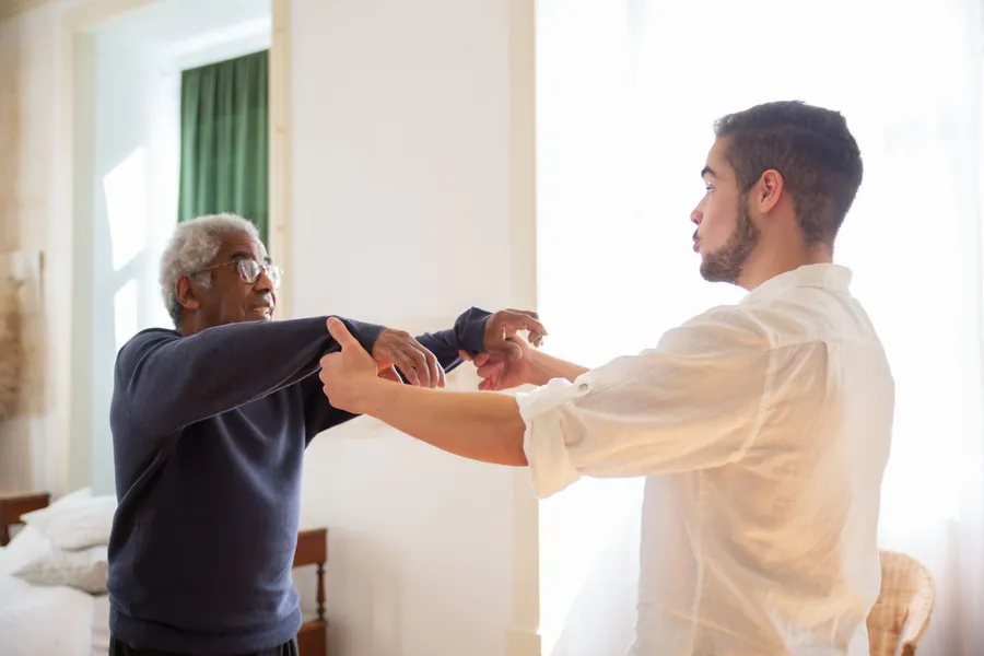 Older person being supported at home during an assessment for kitchen adaptations in Liverpool