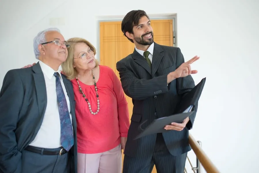 Couple viewing a property with an estate agent indoors