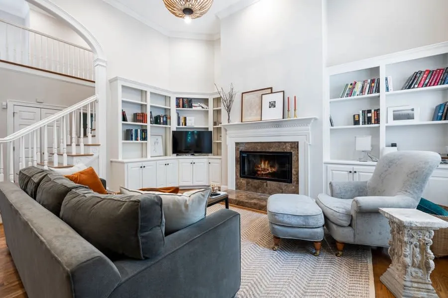 Full-height fitted bookcase beside a fireplace in a period living room