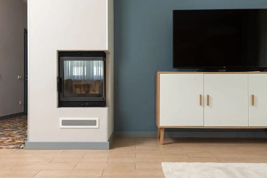 Wall-mounted television on a chimney breast with fitted cabinets in the alcoves