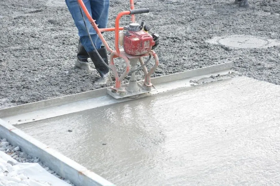 Power trowel smoothing a concrete floor, the kind of base found in post-war Liverpool semis