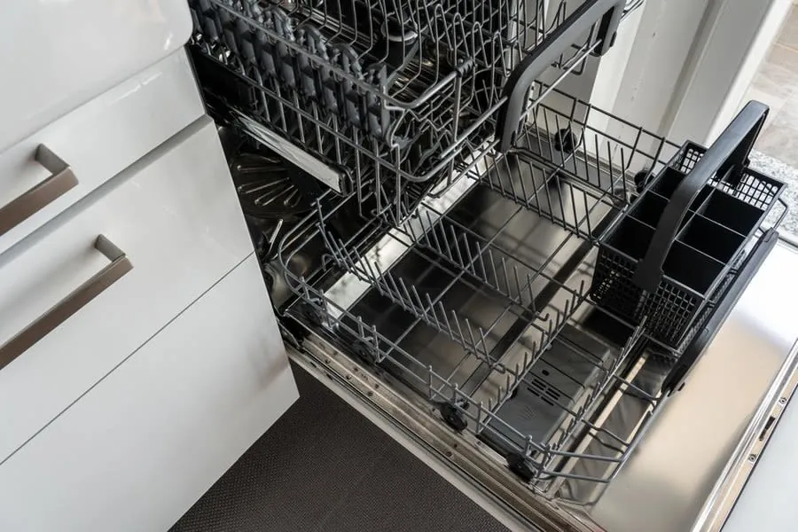 Open dishwasher fitted into a run of handleless kitchen units in Liverpool