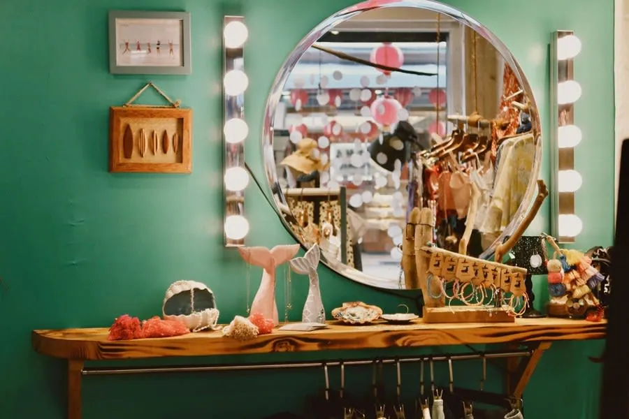 Dressing room corner with a round mirror and warm lighting