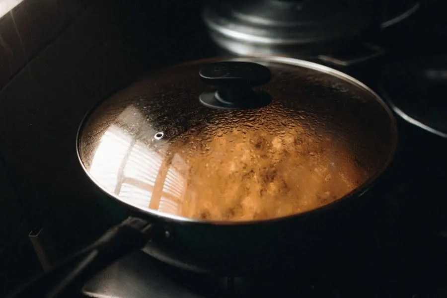 Steam rising from a covered pan on a hob in a Liverpool kitchen