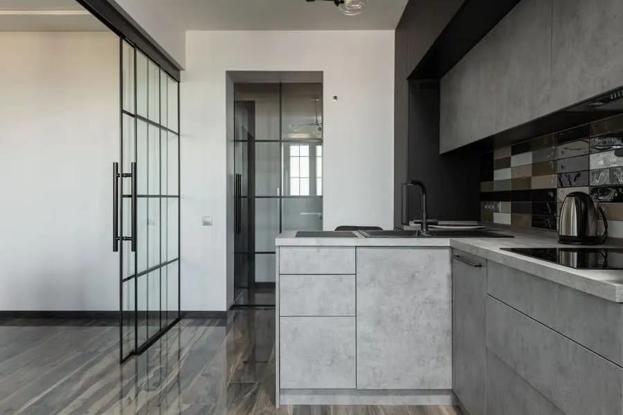 Modern grey fitted kitchen whose units, worktop and hardware will each age at a different rate