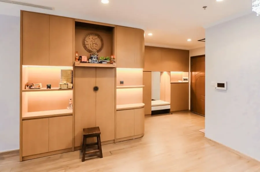 Built-in wooden shelving and cupboards in a minimal home interior