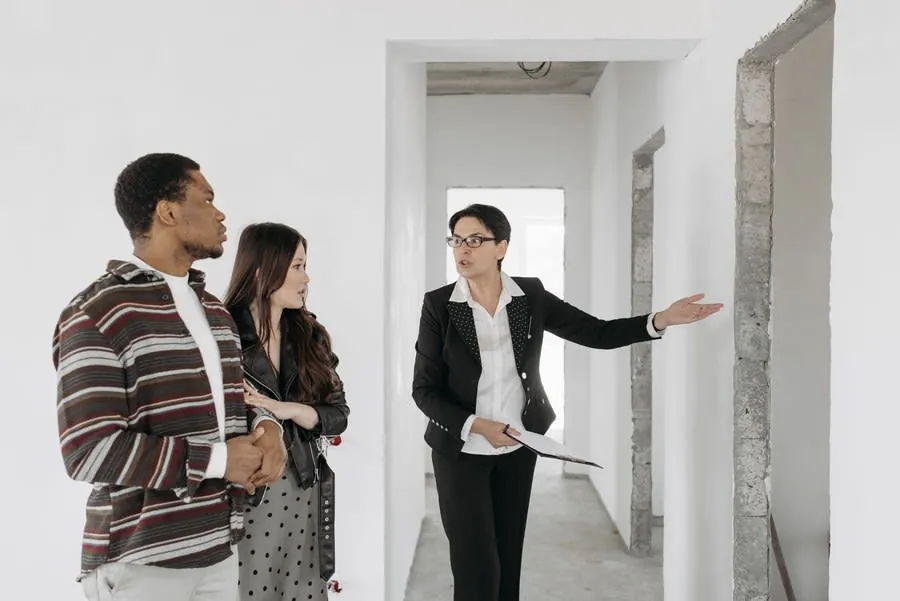 Estate agent showing a couple around a house