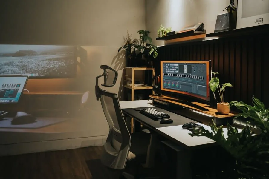 Home office desk with a monitor at eye level and an ergonomic chair