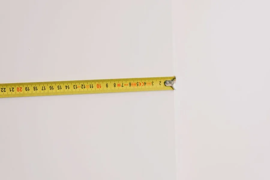 Tape measure against a plain wall in a room being renovated