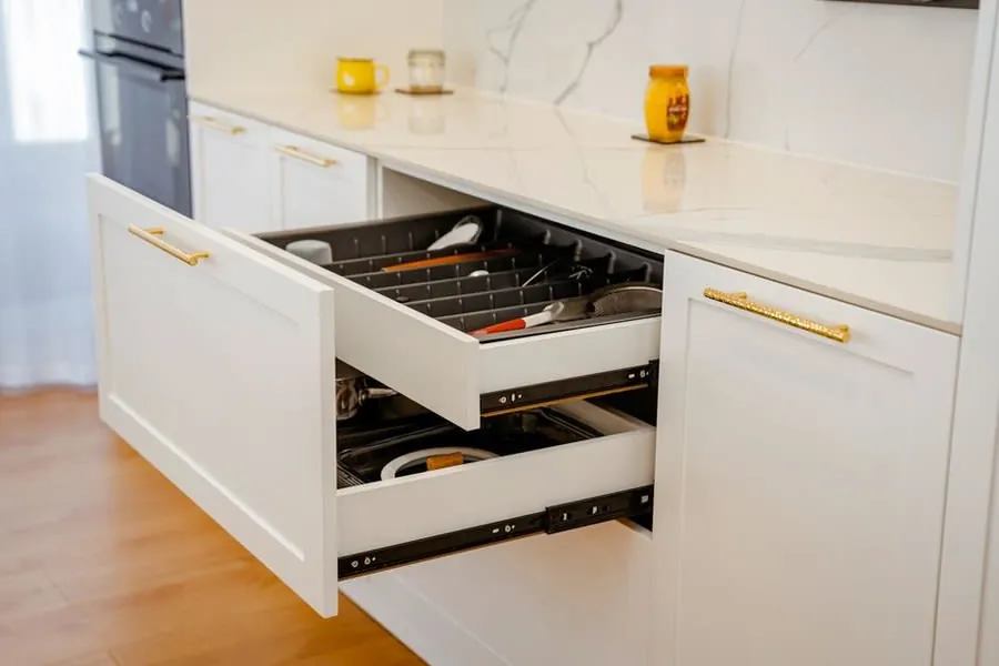 Kitchen drawers pulled open to show the runners that take the most wear in daily use
