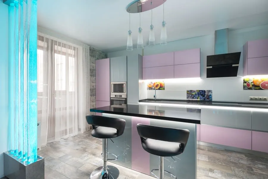 Modern kitchen with pastel cabinets, black island, two stools, and turquoise floor-to-ceiling window blinds