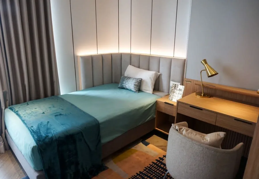 Small bedroom with a single bed, wooden furniture and a window