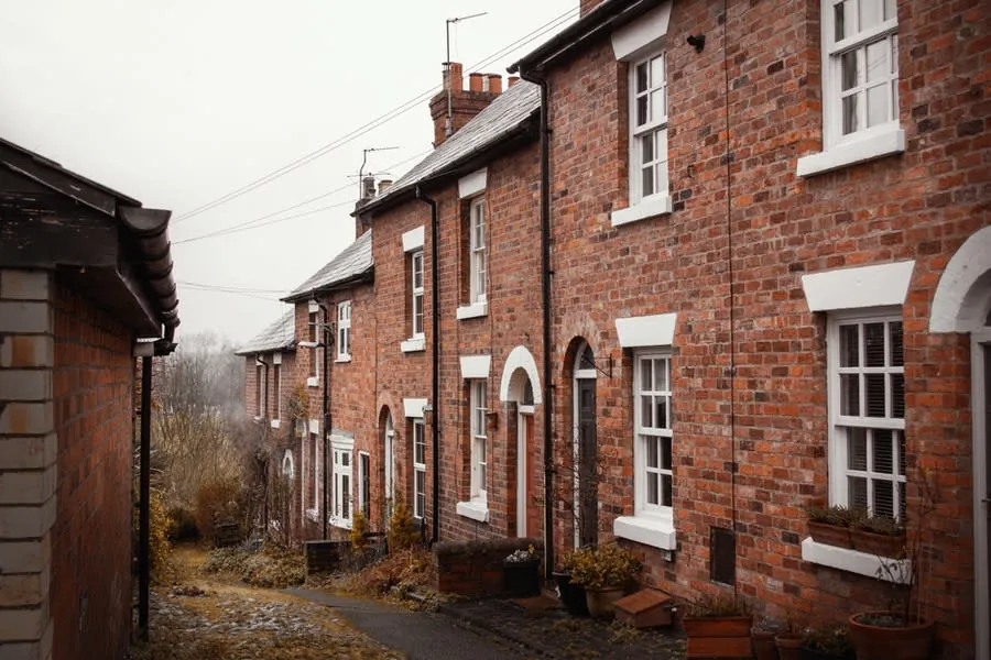 Brick terraced houses of the kind found across Liverpool where kitchen services cluster in the rear outrigger
