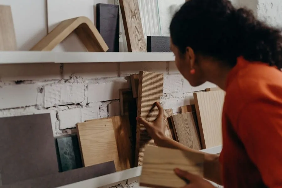 Homeowner comparing timber and board samples in a showroom