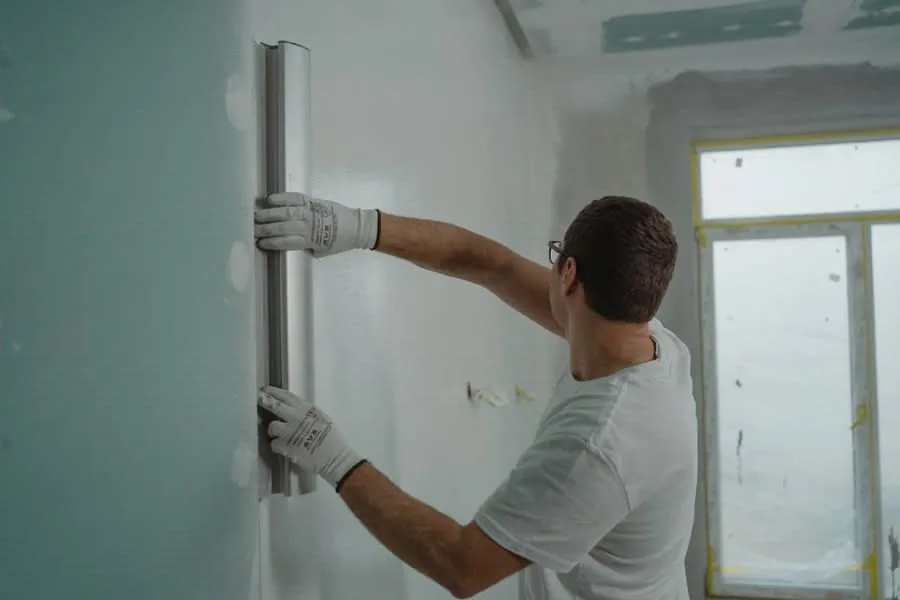 Plasterer working on a kitchen wall during a Liverpool renovation