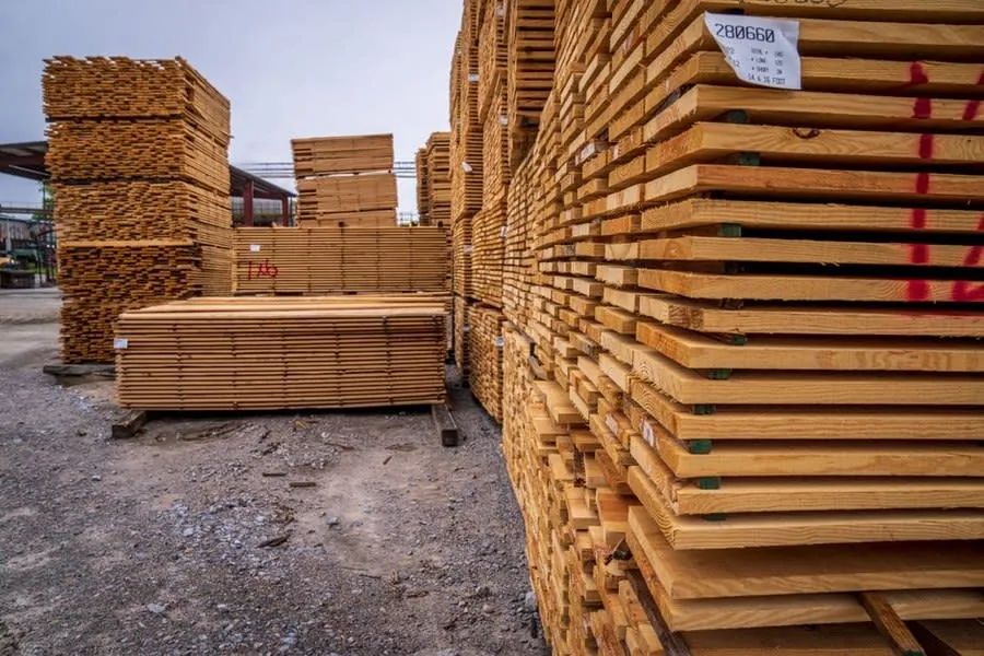 Stacks of timber sheets in a yard, of the kind used for plywood kitchen carcasses