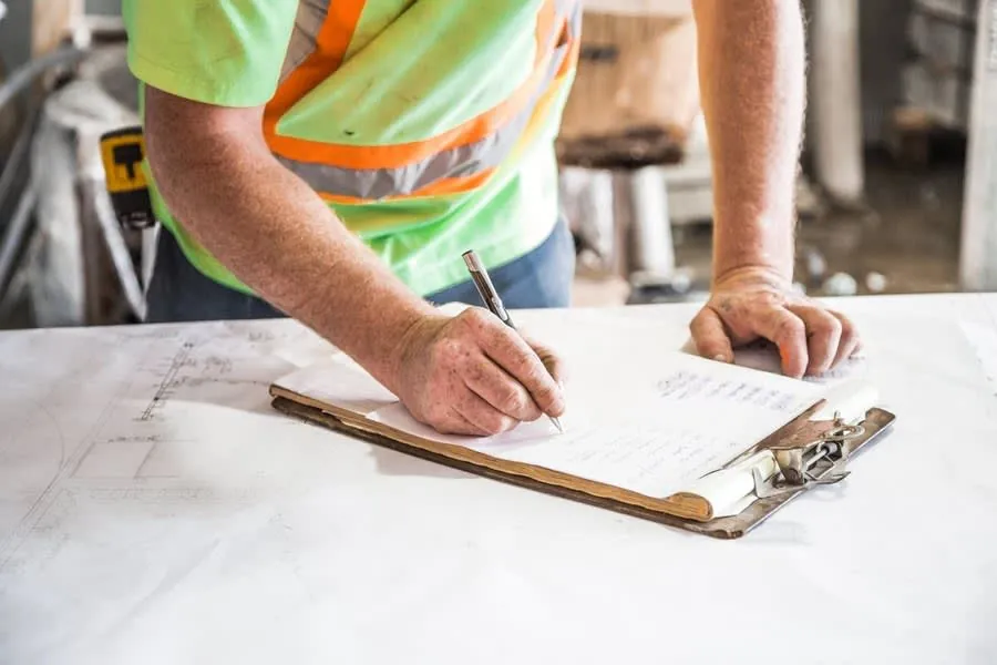 Site notes being written on a clipboard during a Liverpool kitchen project