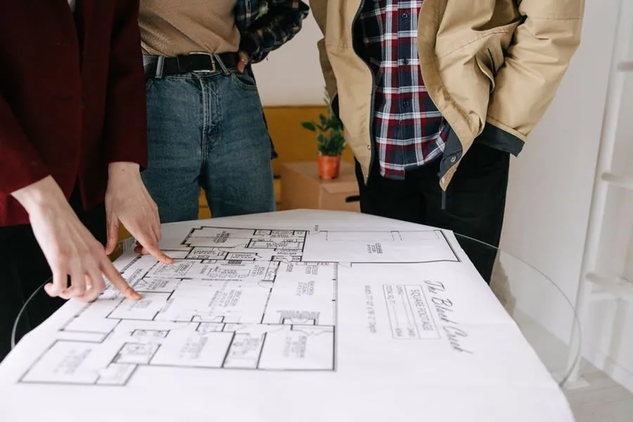 Homeowners going through kitchen plans and quotes before signing