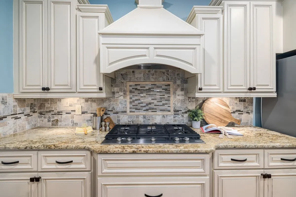 Refreshed kitchen with new cabinet doors, wooden accents and a marble-effect worktop