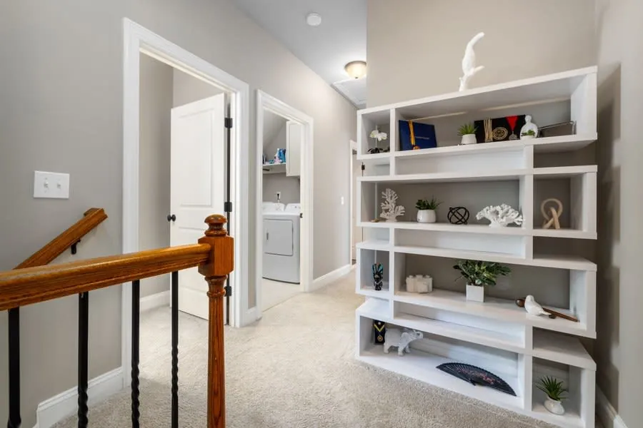 Contemporary hallway with a fitted white shelving unit against the wall