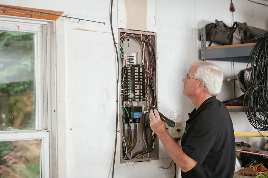 Electrician checking a residential consumer unit inside a home