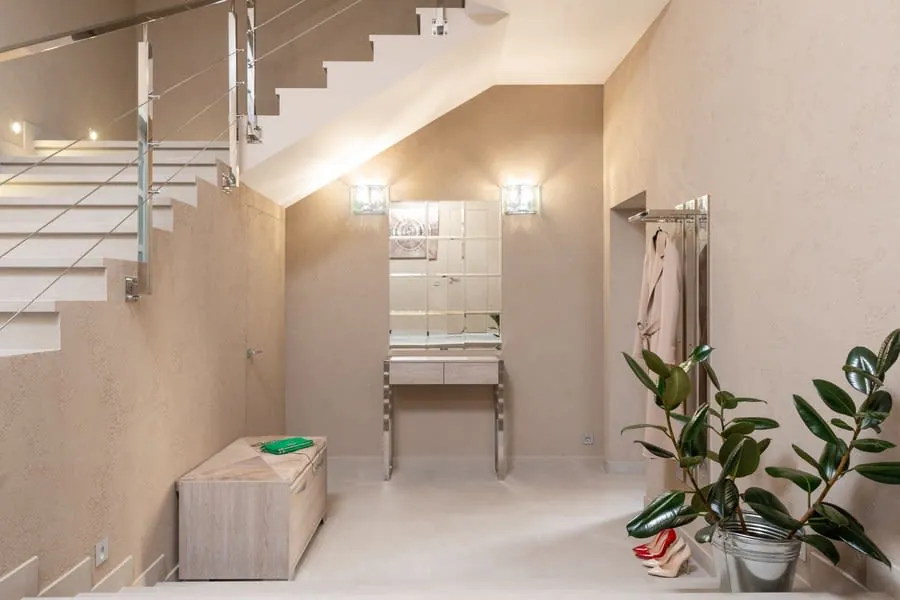 Light contemporary hallway with a staircase rising to the first floor