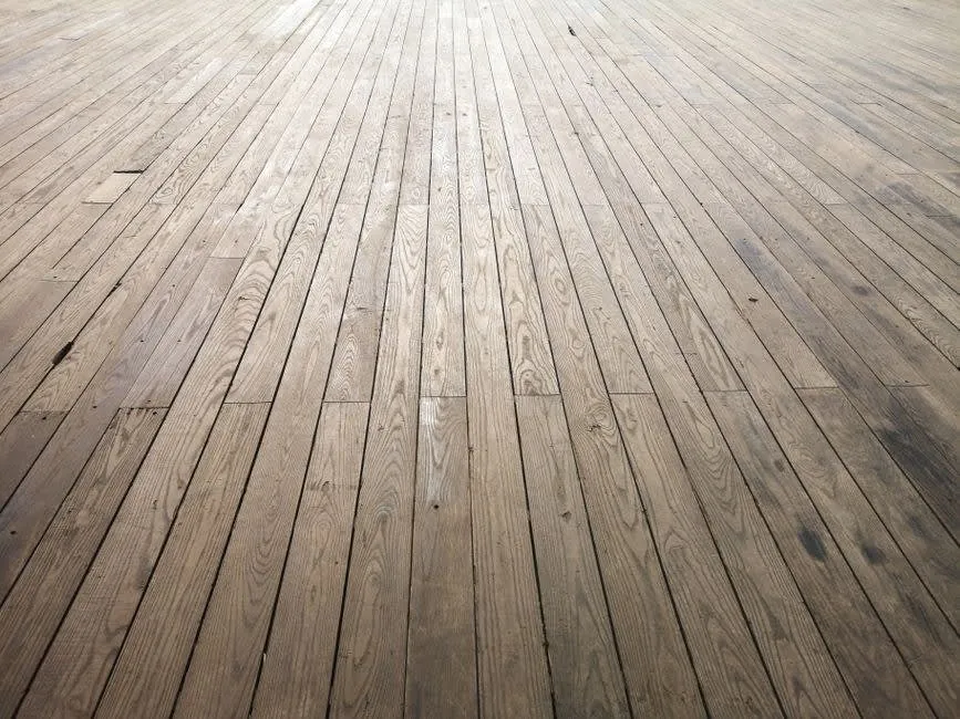 Aged timber floorboards exposed in a Liverpool terraced house before a new kitchen floor is laid