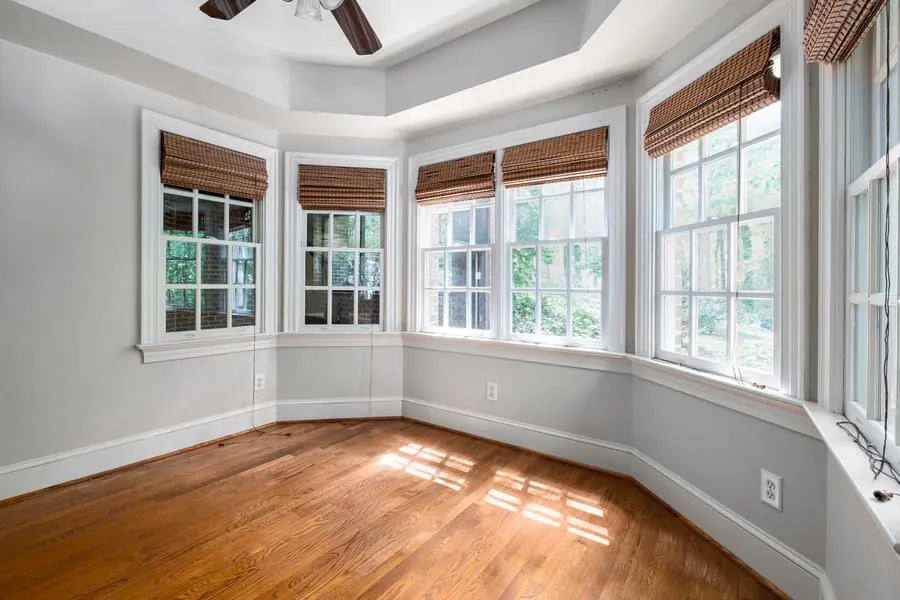 Empty room with a bay window and stripped wooden floor