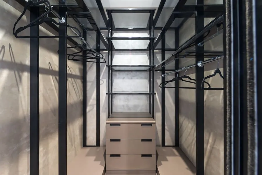 Fitted wardrobe interior with a bank of drawers between hanging rails