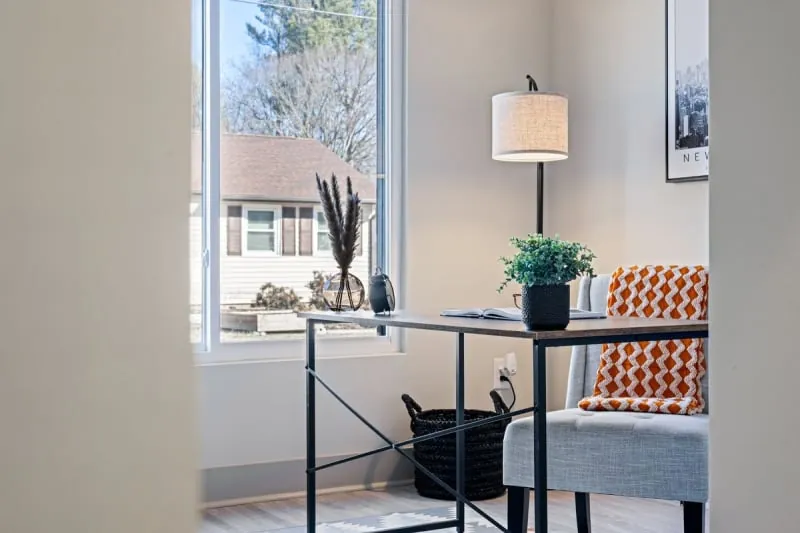 Minimalist home office desk beside a bright window