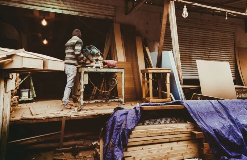 Joiner working on timber components at a workshop bench