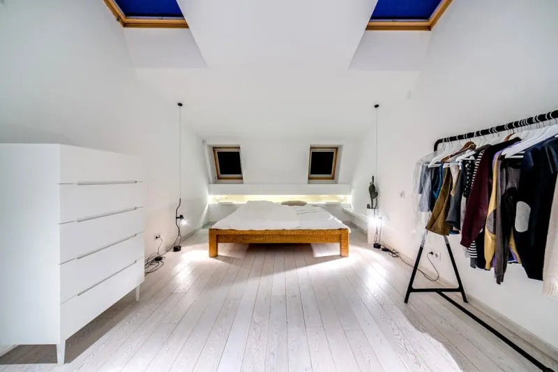 Loft conversion bedroom with skylights and sloped ceiling