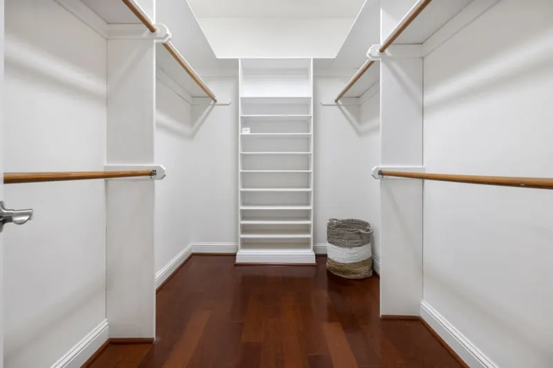 Open wardrobe system with wooden floors, shelves and hanging rails