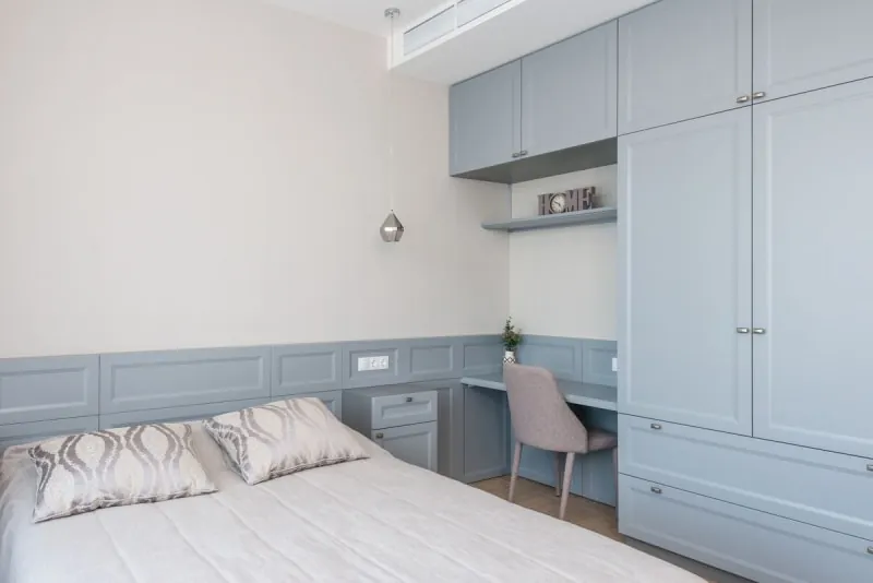 Spare room workspace with built-in cabinetry and desk in soft blue tones