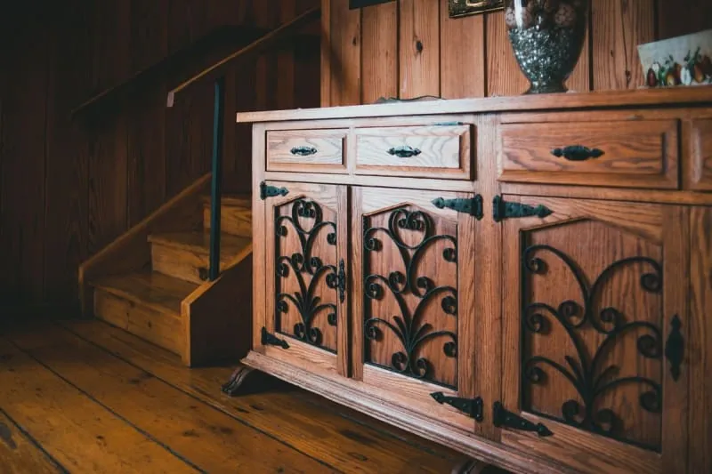 Wooden storage cabinet fitted beside a staircase in a period home