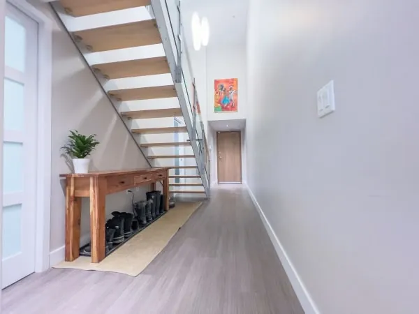 Hallway staircase with fitted storage built into the void below